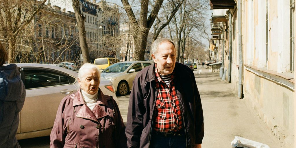a group of people standing on a sidewalk
