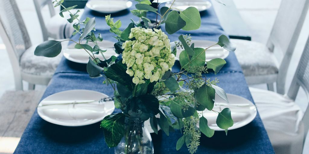 green and white flower centerpiece on table
