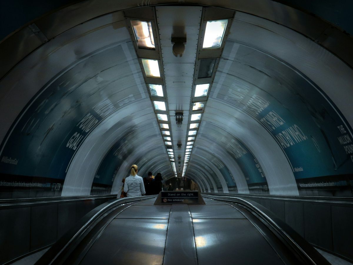 people walking on tunnel during daytime