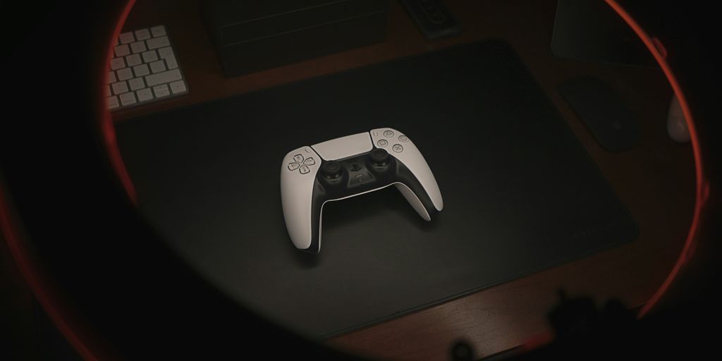 white game controller on black table