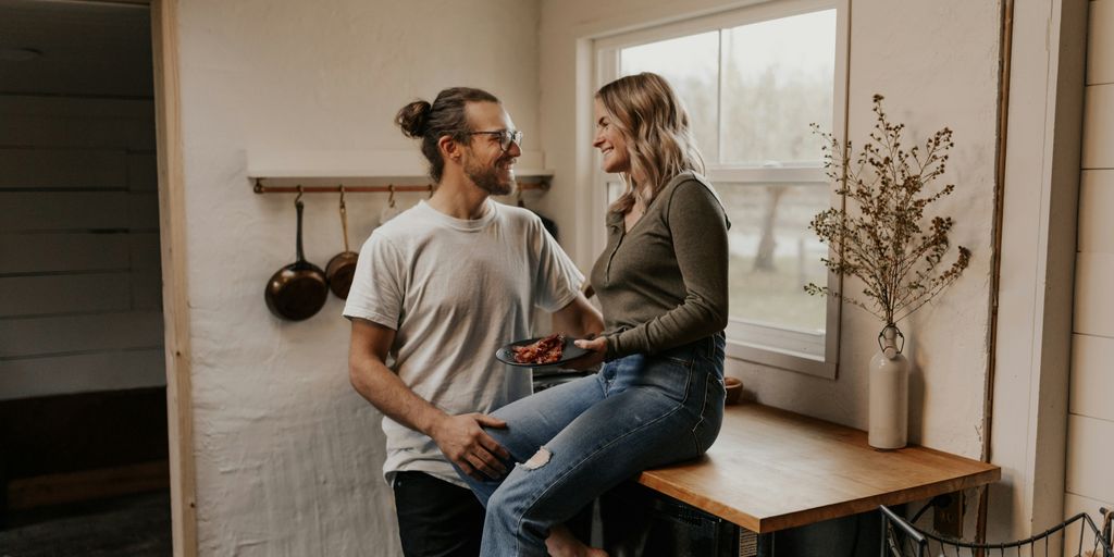 man in gray crew neck t-shirt sitting beside woman in gray long sleeve shirt