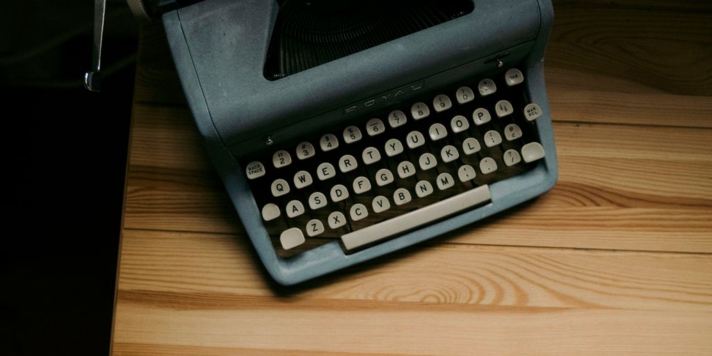 an old fashioned typewriter sitting on a wooden table