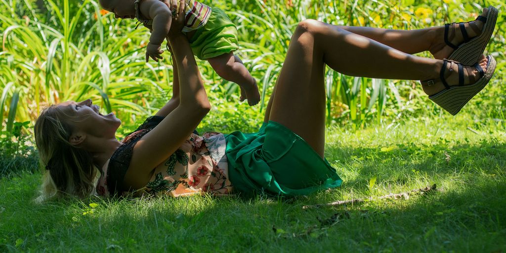 a man and woman lying in the grass