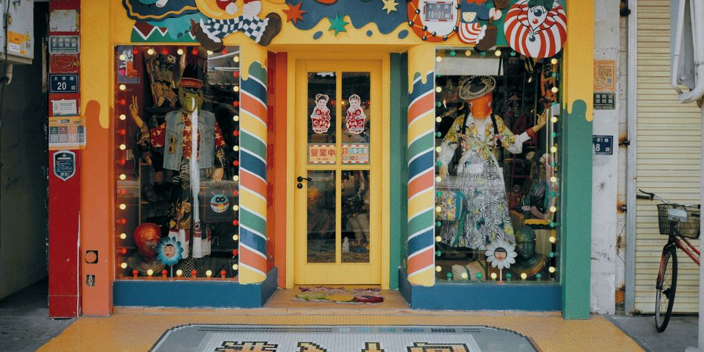 a brightly colored storefront with a large rug in front of it