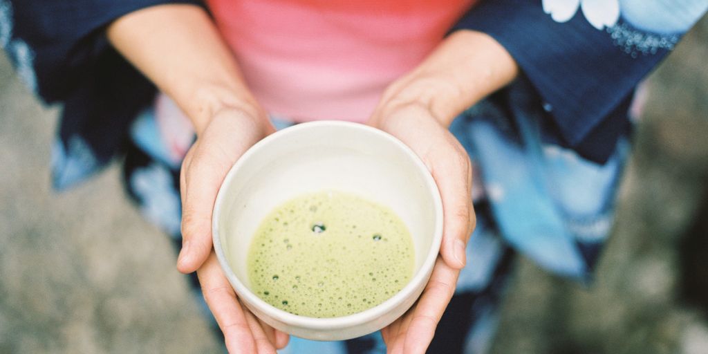 Geisha holding near empty bowl of soup