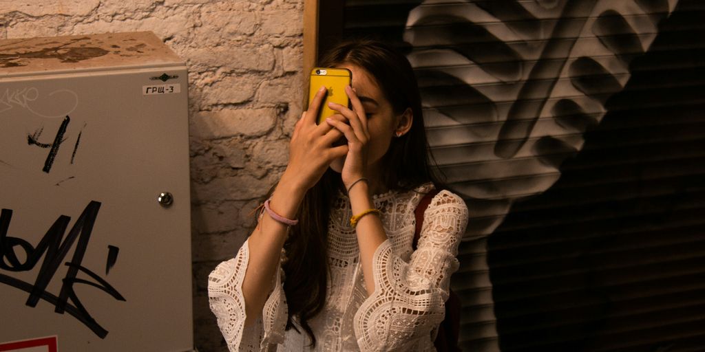 woman facing iPhone