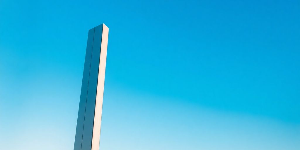 Brightly lit pylon structure against a clear sky.