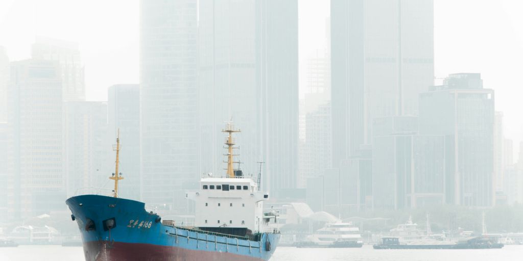 blue and white ship on white sand during daytime