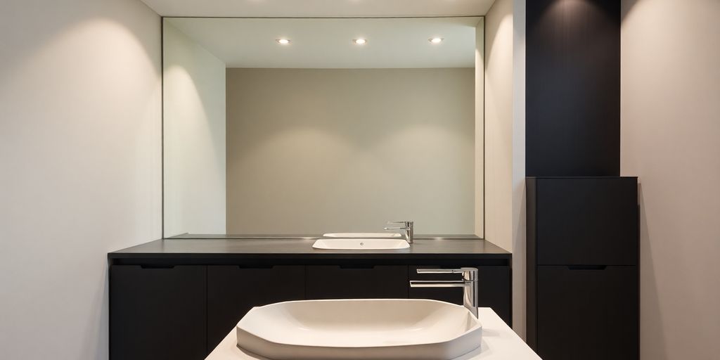 Sleek, modern bathroom with a unique edge sink.