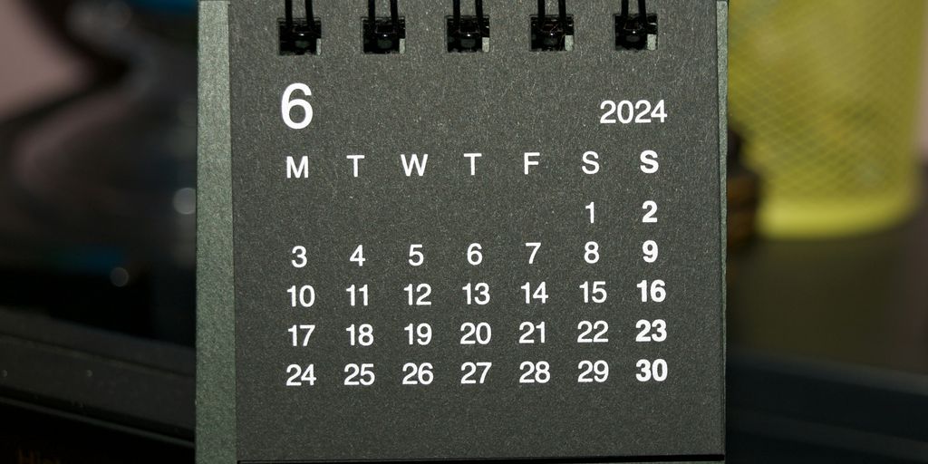 A black and white calendar sitting on top of a table