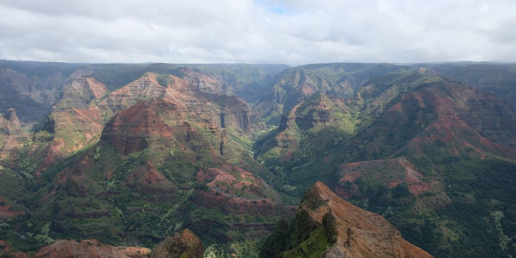 aerial view of mountains under white clouds