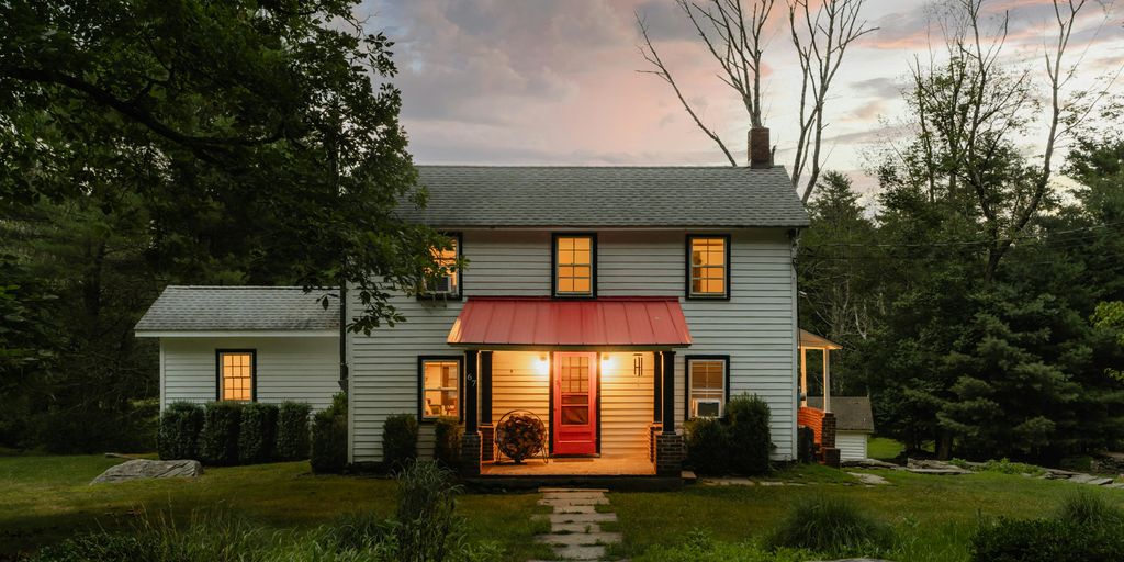 A small white house with a red awning
