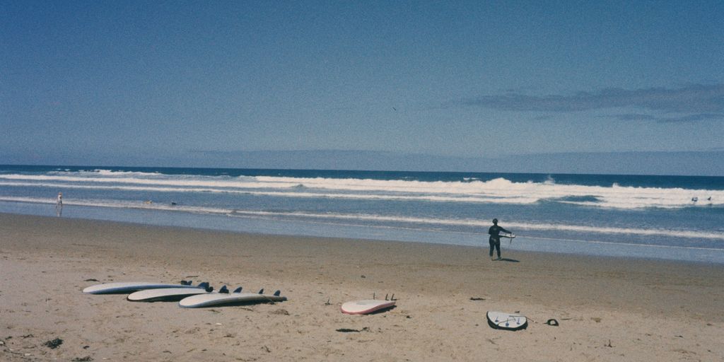 Surfers and surfboards await the waves on the beach.