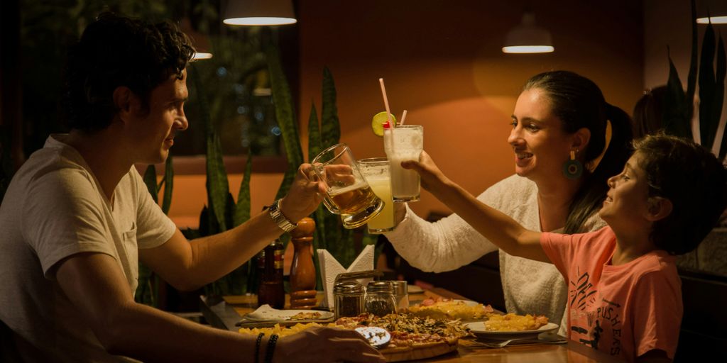 three people having a toast on table
