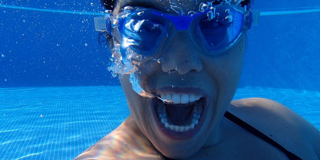 swimmer eating banana poolside