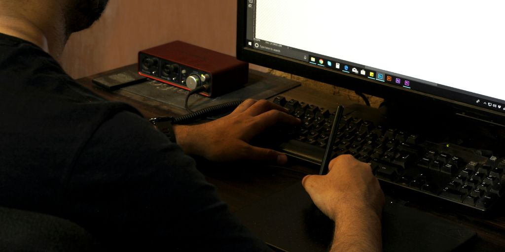 person in black long sleeve shirt using computer