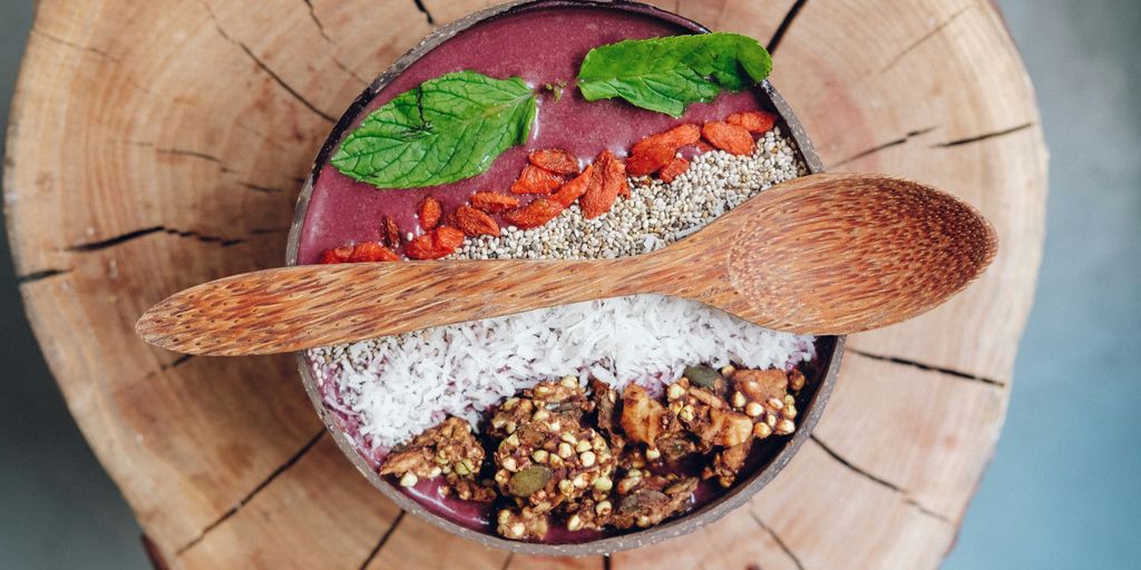 cooked food with wooden spoon and chopping board