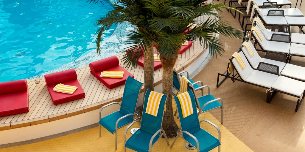 blue and white lounge chairs near swimming pool
