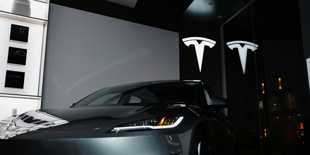 A car parked in front of a large screen