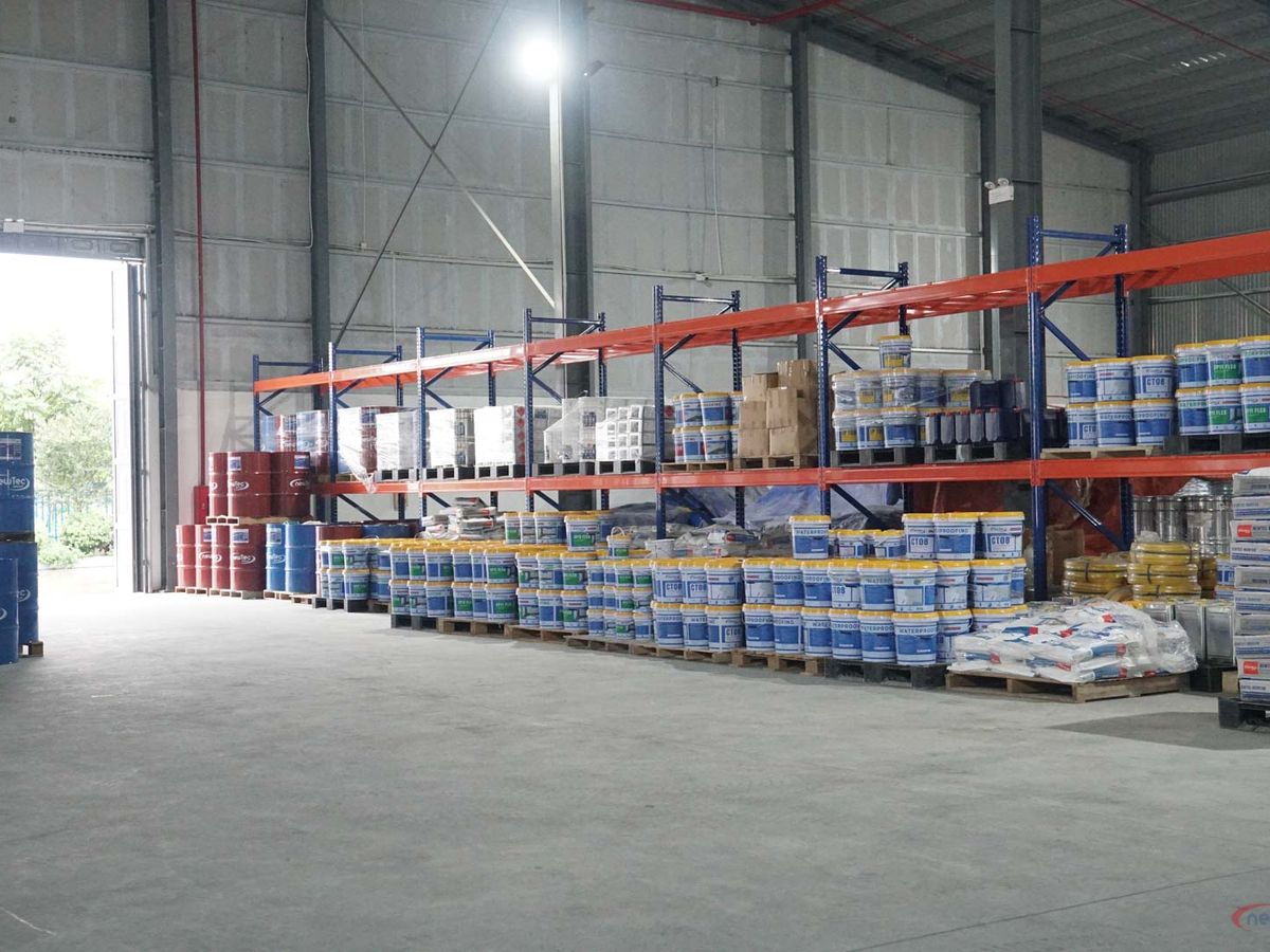 Warehouse interior with shelves stacked with various products.