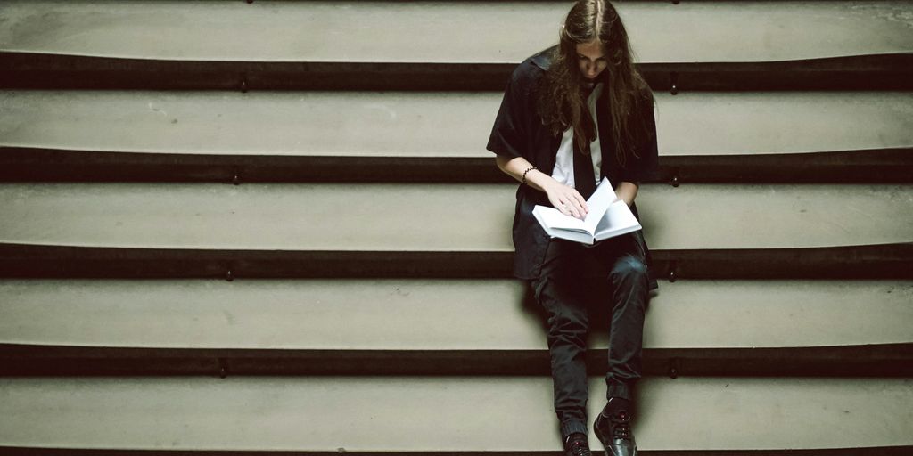 A person sitting on a set of stairs