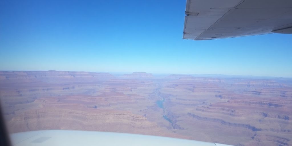 A small airplane flies over the majestic Grand Canyon.