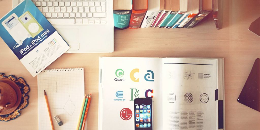 pencils and smartphone on top of books