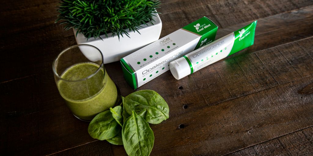 green leaf beside white and green box