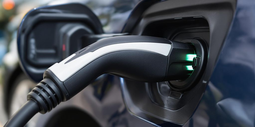 Electric vehicle charging port with cable connected.