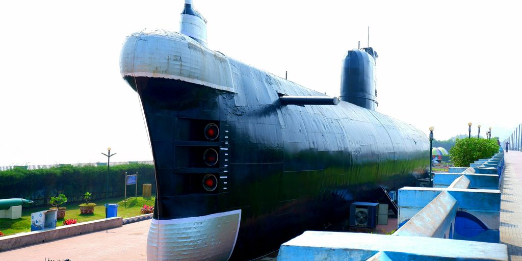 a large black submarine sitting on top of a sidewalk