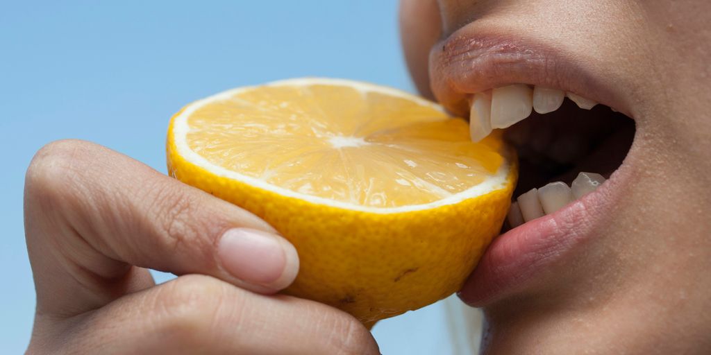 person holding orange fruit during daytime