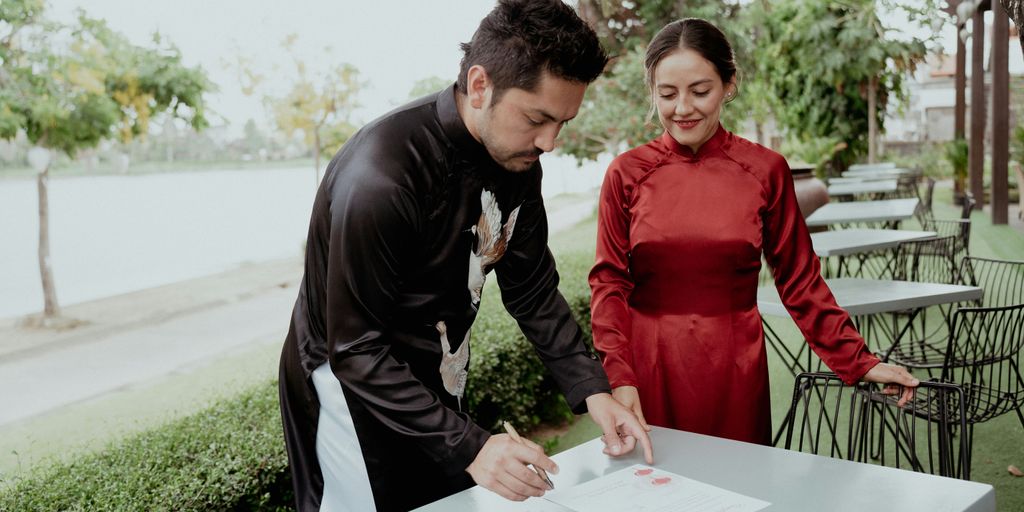 a man and a woman standing next to a table