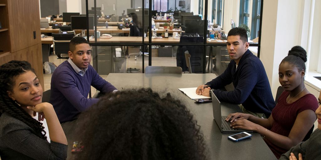 a group of people sitting around a table