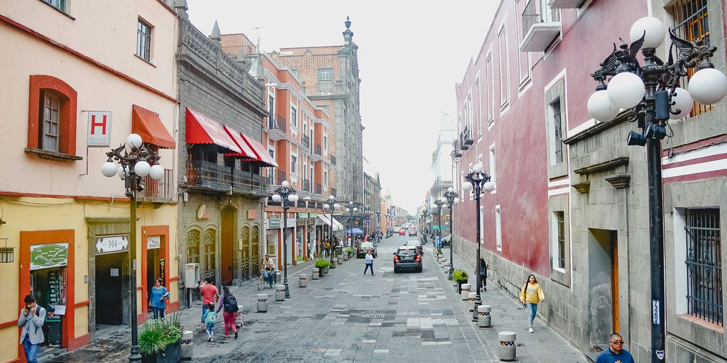 a city street with people walking down it