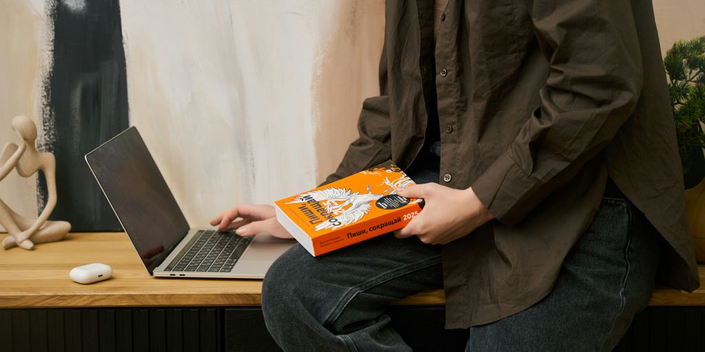 a person sitting on a table with a laptop