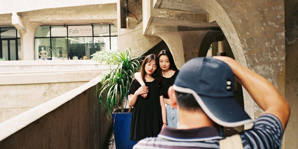 a man taking a picture of two women