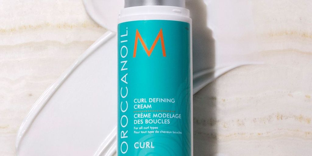 Bottle of Moroccanoil Curl Defining Cream on a textured surface.