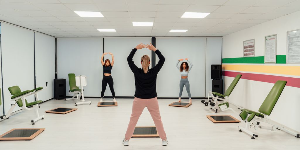 a group of people doing exercises in a room