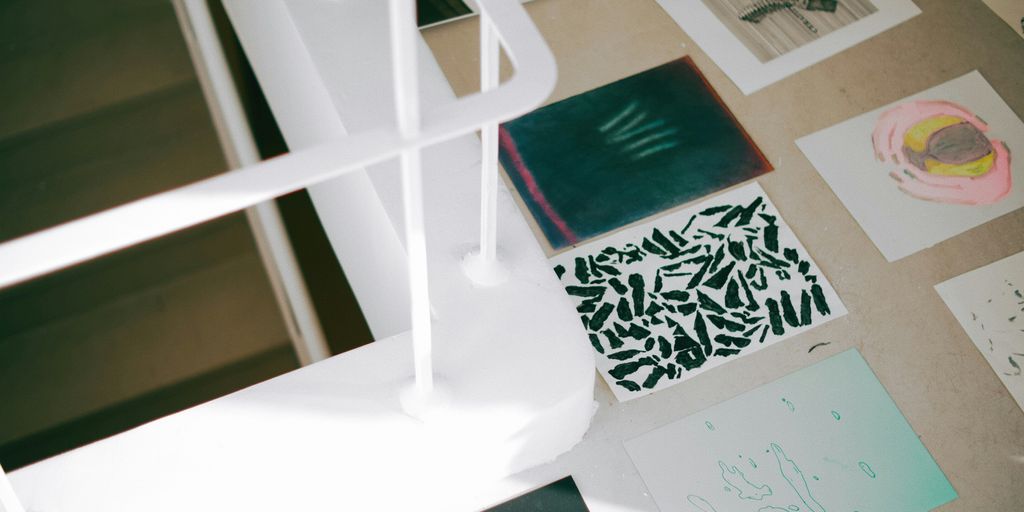 a desk with a lot of papers and pictures on it