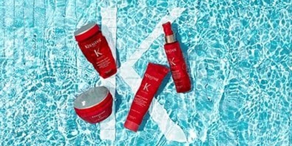 Skincare products arranged on a pool's water surface.