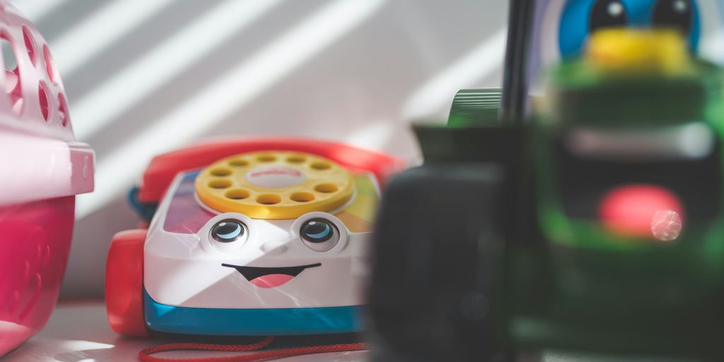 a toy phone sitting next to a toy car