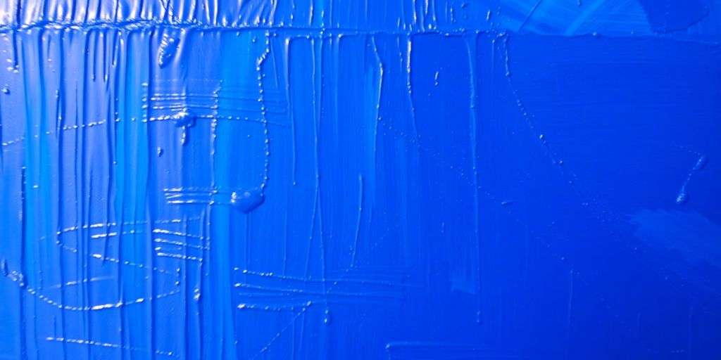 Close-up of a vibrant blue oil painting.
