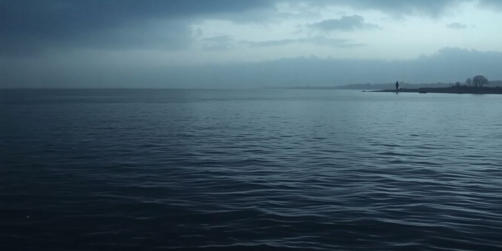 Calm Aberdeen waters with a distant silhouette on shore.