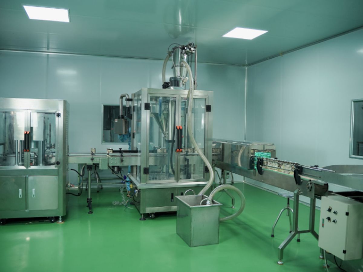 Clean industrial space with machines and conveyor belt system.