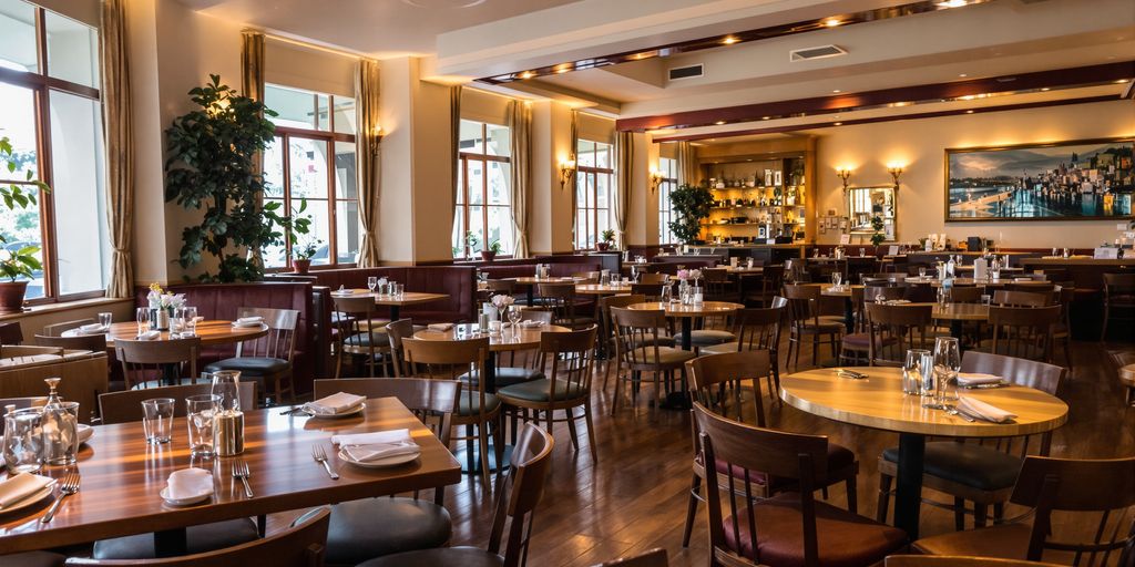 Elegant restaurant dining area with polished tables and soft lighting.