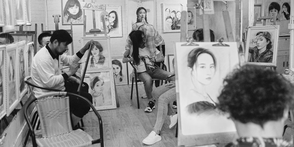 grayscale photo of woman and man sitting on chair