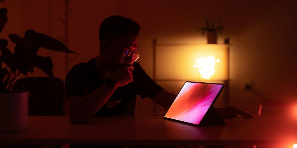 a man sitting in front of a laptop computer