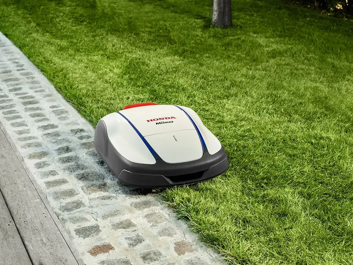 Robot lawn mower on a well-maintained grassy area.