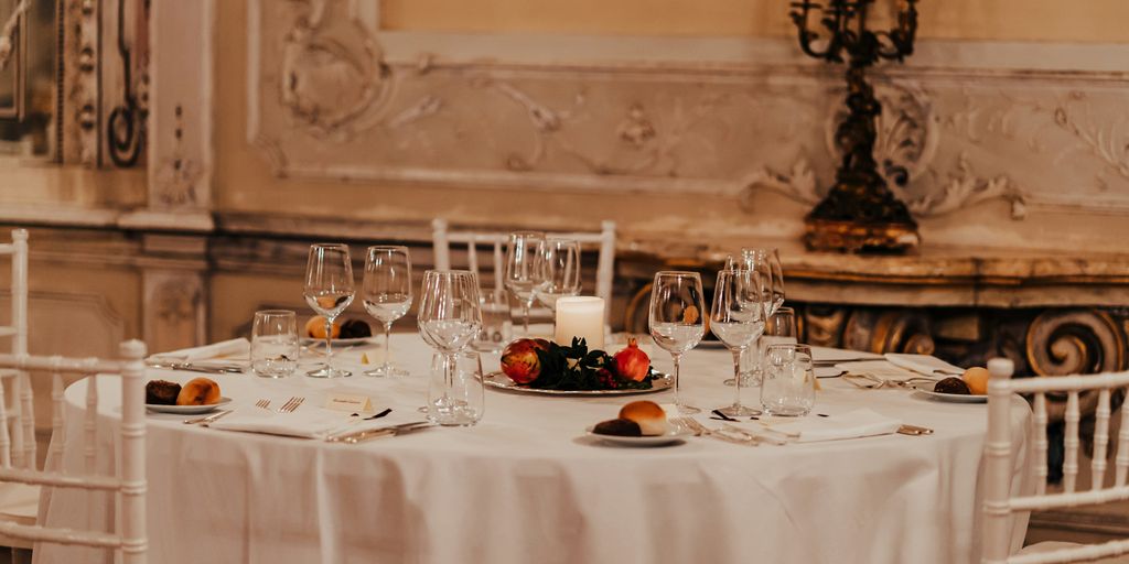 white table cloth with plates and glasses