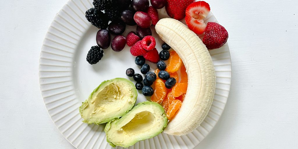 a white plate topped with fruits and vegetables